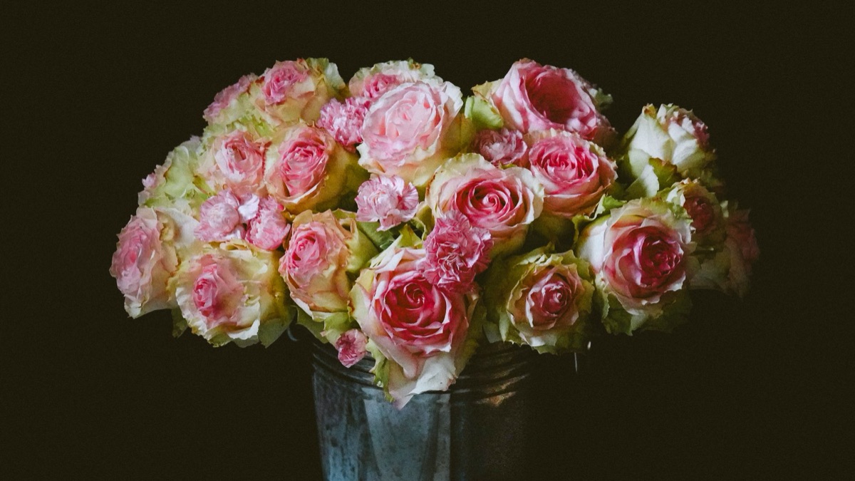 Historical roses in vase with decorative arrangement