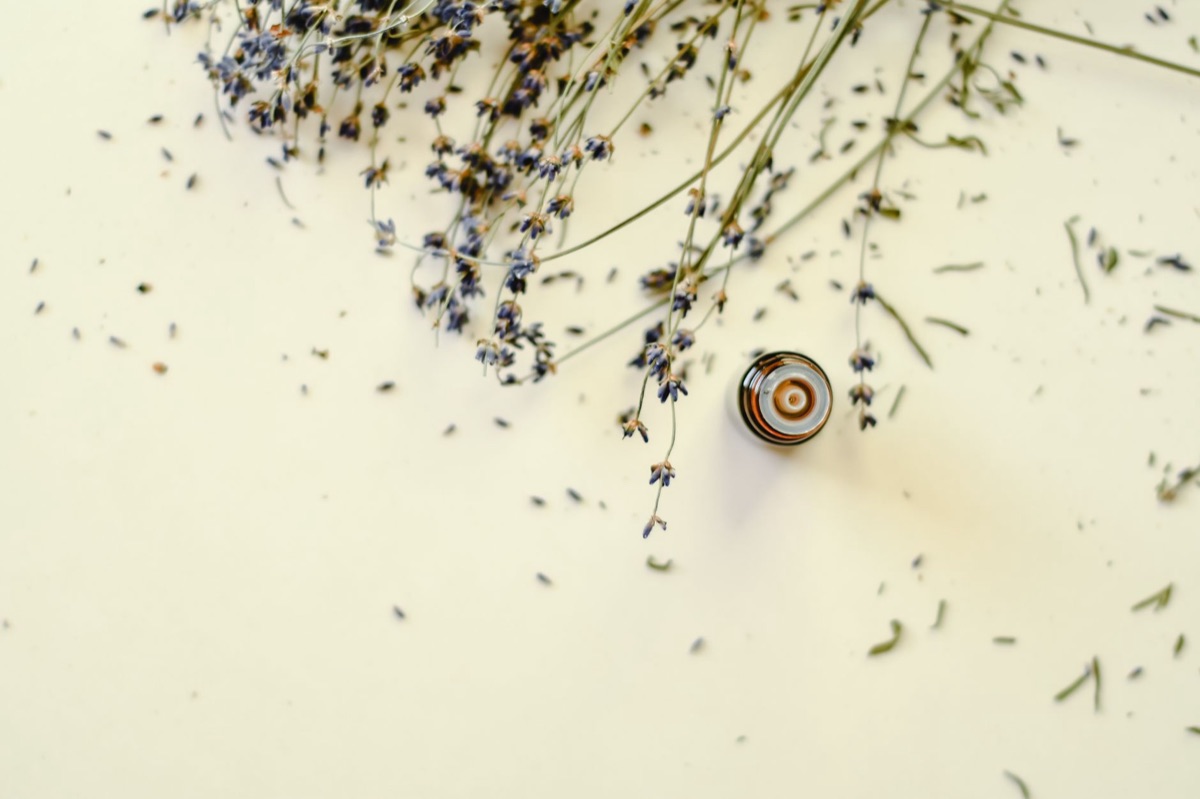 Lavender essential oil bottle with naturalistic background
